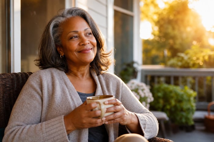 Woman with coffee on porch